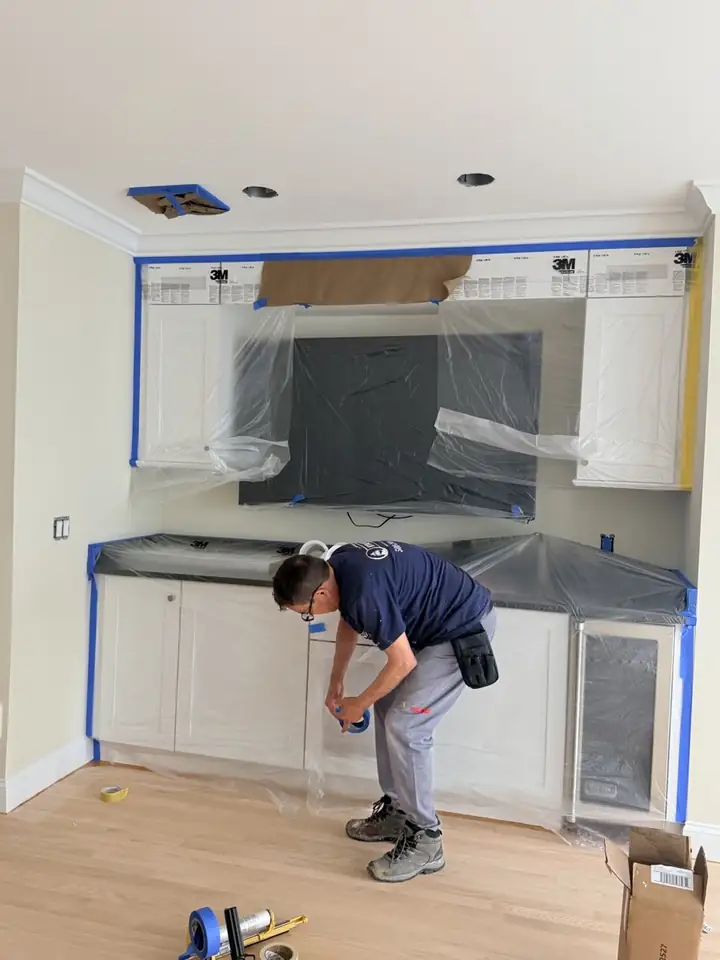 Hyannis Painting painter taping and masking a kitchen before painting